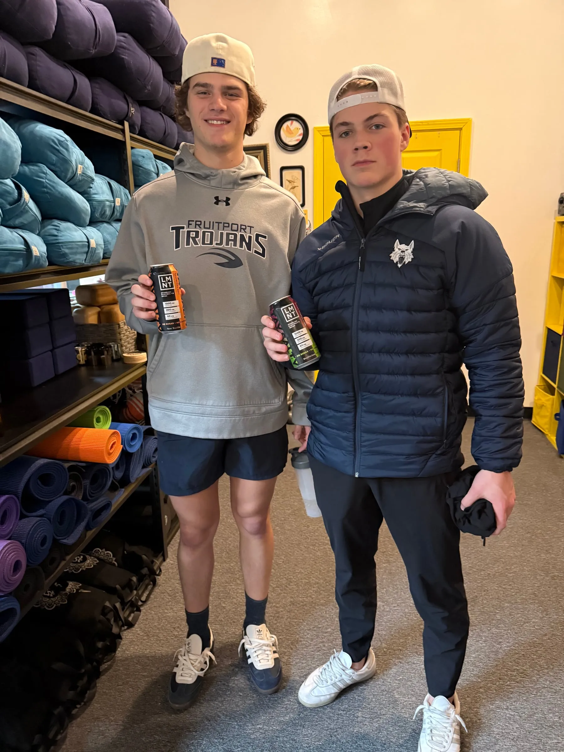 Two young hockey players standing in the studio