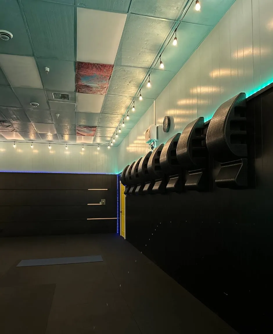 Studio room with a long mirror wall and teal accent lights